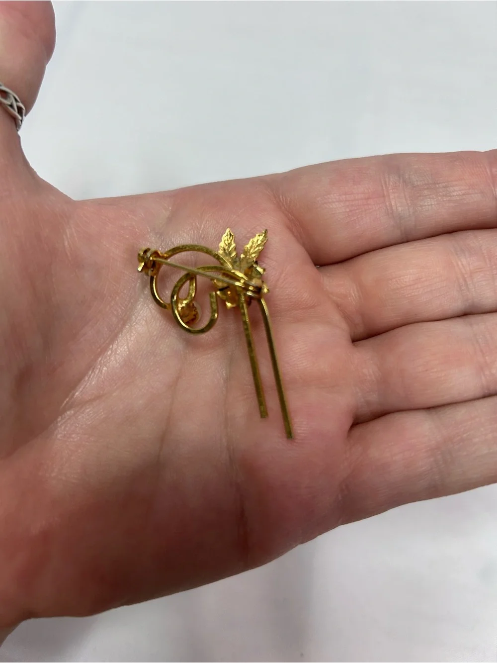 Delicate gold tone flower pin